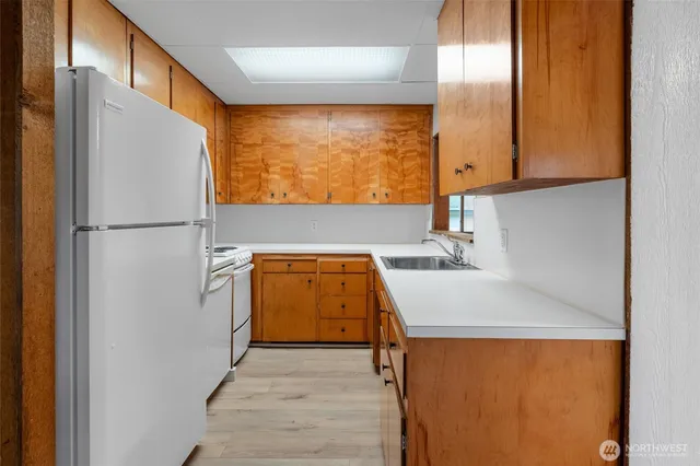 a bathroom with a sink and a refrigerator