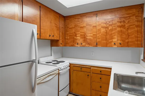 a kitchen with a refrigerator and cabinets