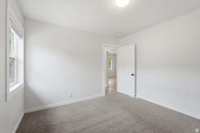215 East 300 South Logan, UT 84321 - Photo 11 of 32 Unfurnished room featuring baseboards and carpet floors
