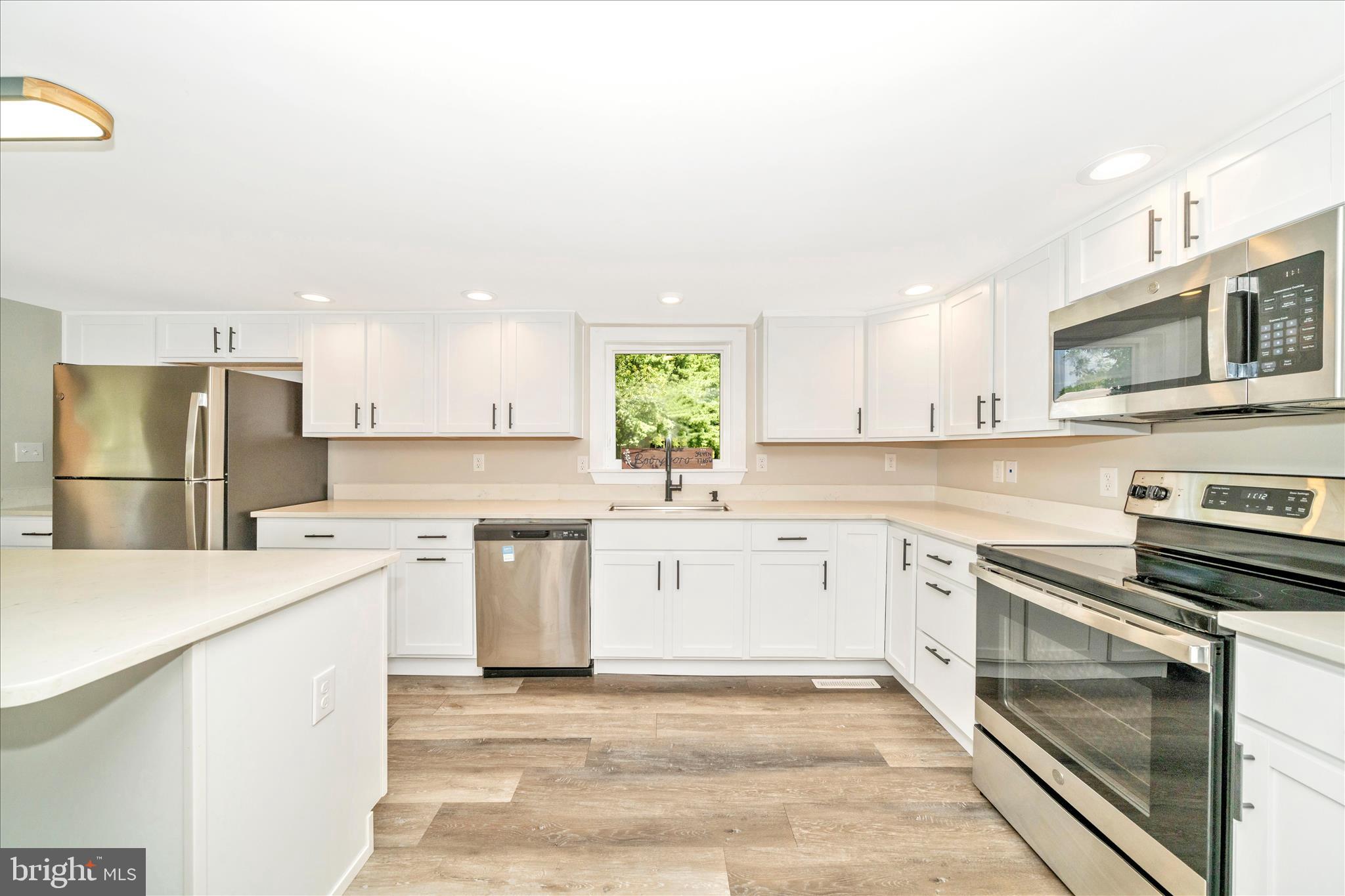 20724 Netz Road Boonsboro, MD 21713 - Photo 11 of 40 a large kitchen with stainless steel appliances granite countertop a stove a sink dishwasher and a refrigerator