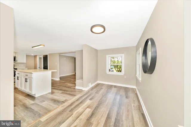 a view of a livingroom with wooden floor and window