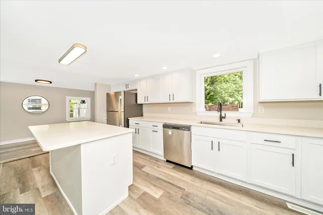 a view of a livingroom with wooden floor and window
