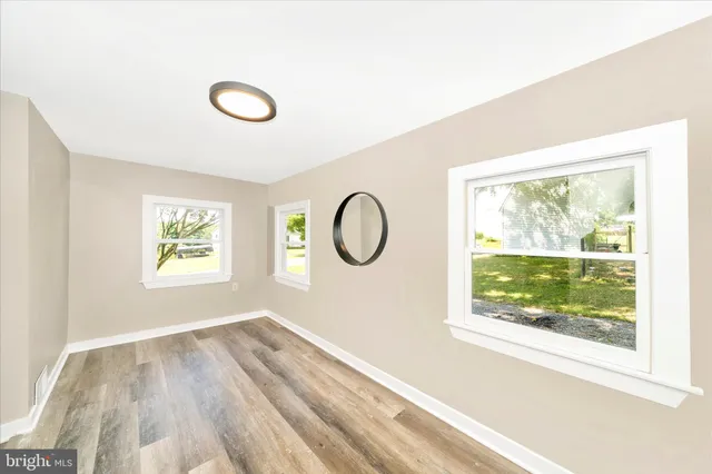 a bathroom with a tub a sink and a large window