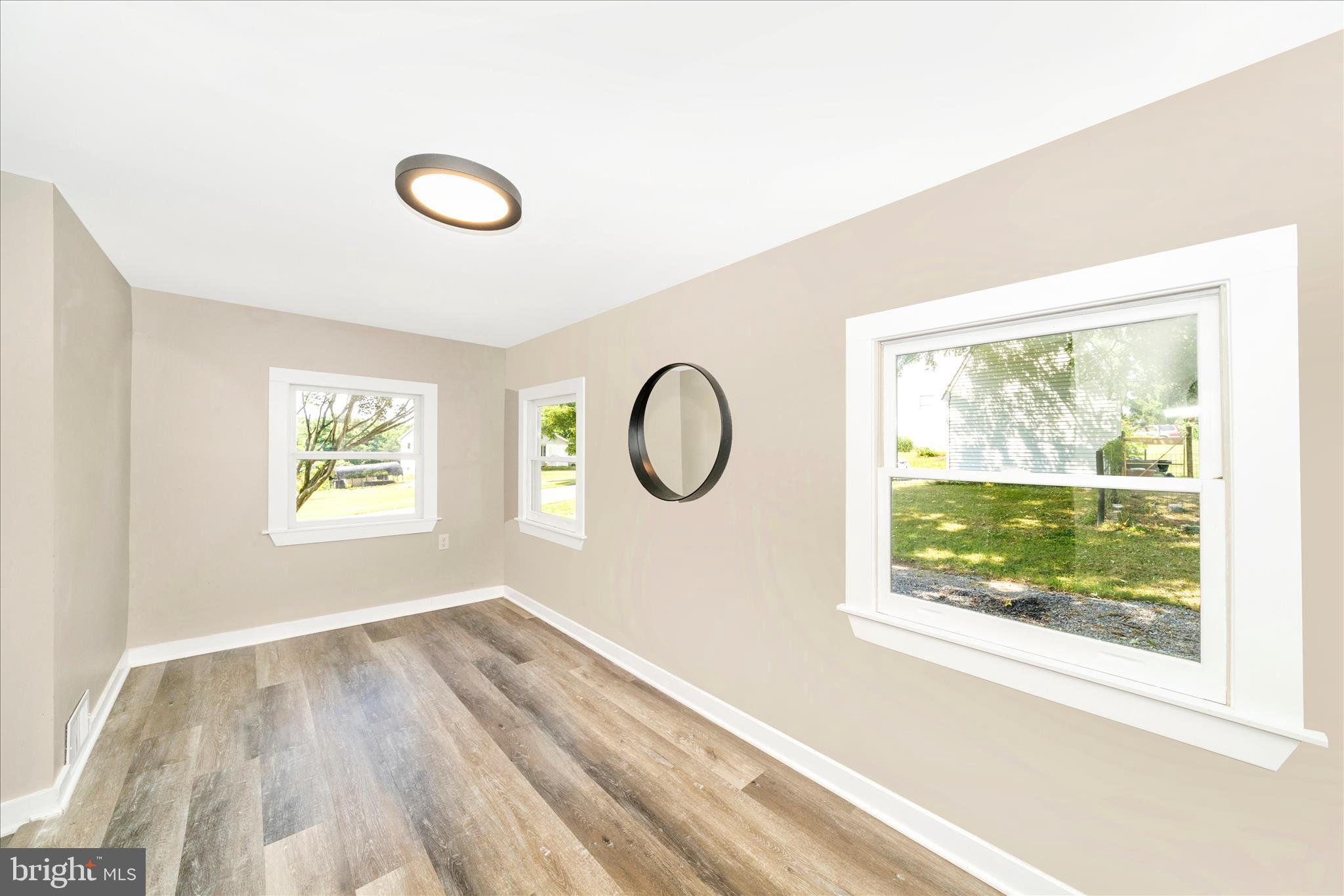 20724 Netz Road Boonsboro, MD 21713 - Photo 14 of 40 a view of a livingroom with wooden floor and window