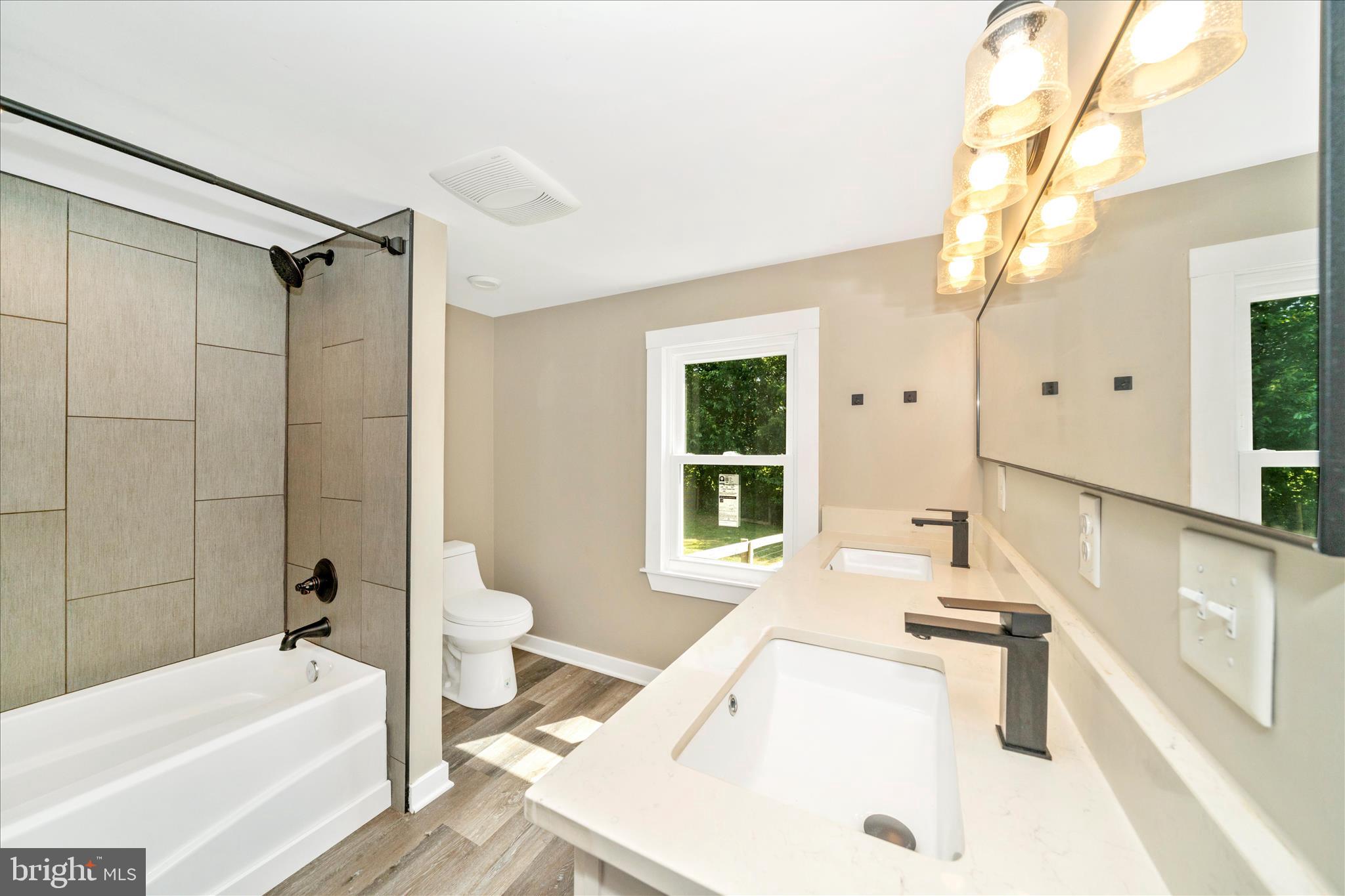 20724 Netz Road Boonsboro, MD 21713 - Photo 17 of 40 a bathroom with a tub a sink and a large window