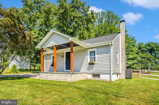 a view of a house with a yard and sitting area