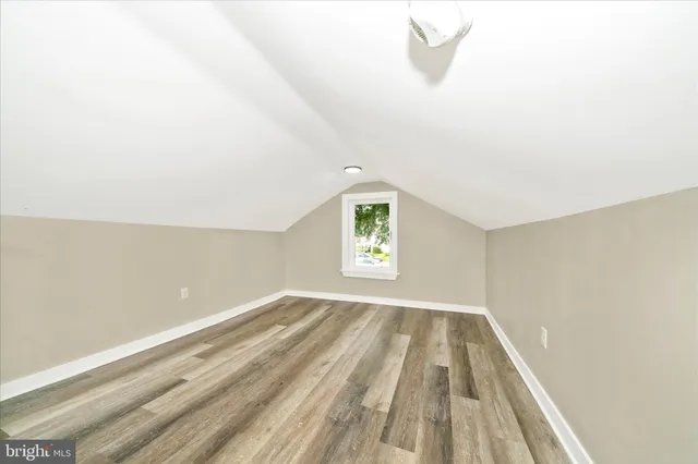 a view of a room with wooden floors