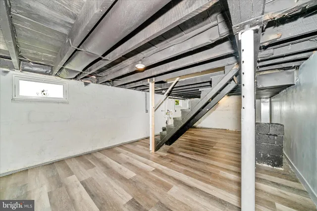 a view of deck with wooden floor and fence with a bench