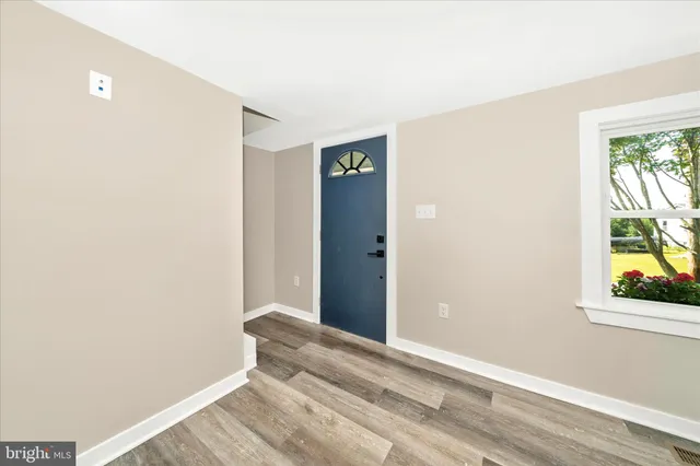 a view of room with window and hardwood floor
