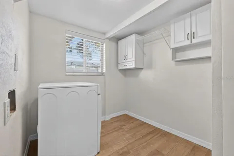 a view of storage and utility room with wooden floor