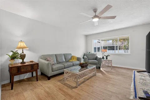 a living room with furniture a chandelier and a window