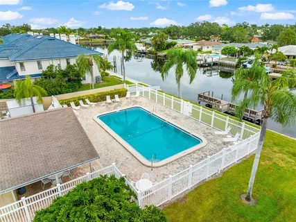 a view of a swimming pool with a patio and a yard