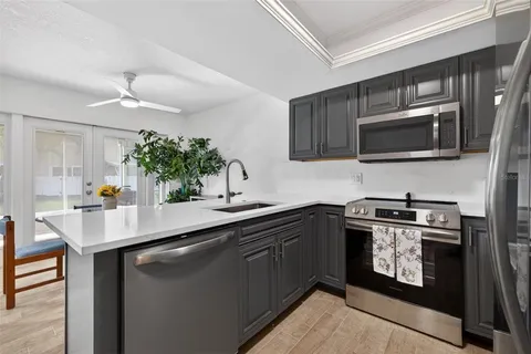 a kitchen with a sink stove and microwave