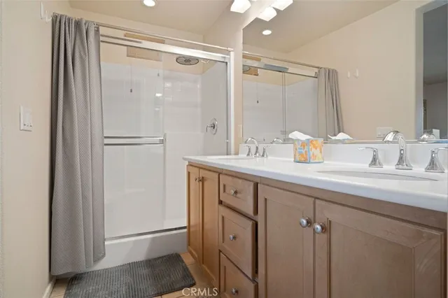 a bathroom with a shower sink and mirror