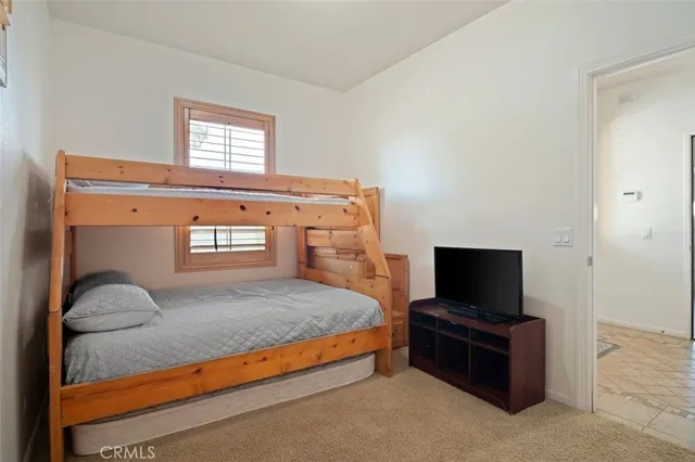 a bedroom with a bed and flat screen tv
