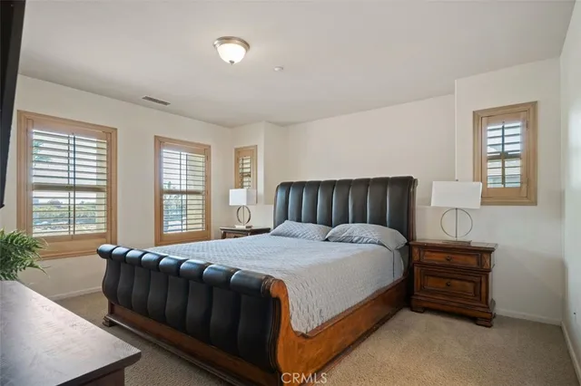 a bedroom with a bed and window