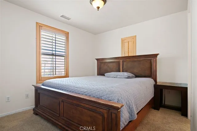 a bedroom with a bed and window