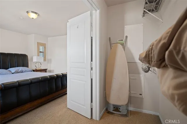 a bedroom with a bed and a mirror