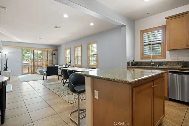 a kitchen with a sink a counter cabinets and appliances