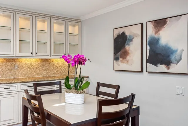 a view of a dining room with furniture and a potted plant