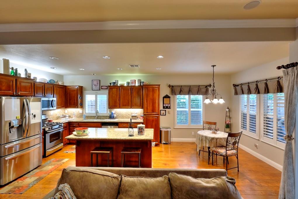 4152 Post Oak Drive Turlock, CA 95382 - Photo 31 of 71 a kitchen with stainless steel appliances granite countertop a stove and a refrigerator