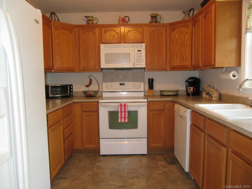 417 St Lukes Church Road Kings Mountain, NC 28086 - Photo 10 of 19 a utility room with stainless steel appliances a stove a sink and a microwave