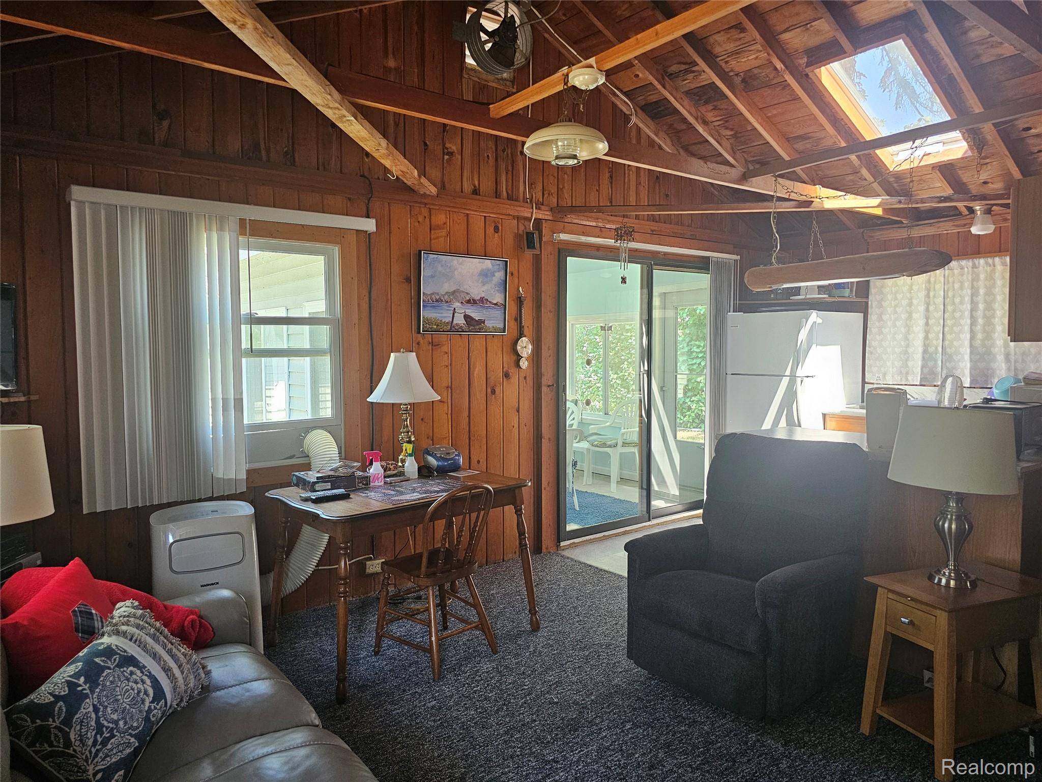 4682 Port Austin Road Caseville, MI 48725 - Photo 7 of 21 Living room with skylight and carpet.