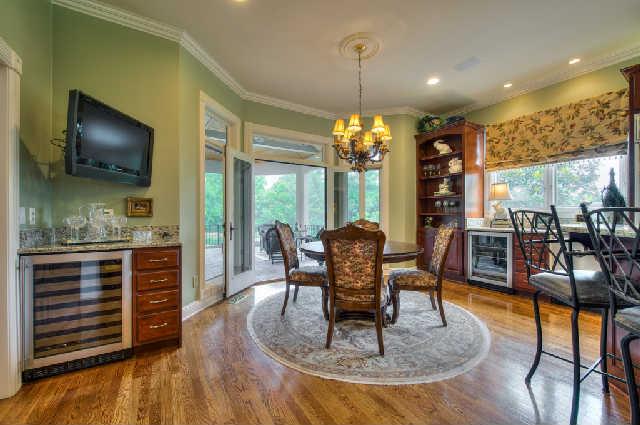 914 Overton Lea Road Nashville, TN 37220 - Photo 7 of 20 a dining room with furniture a chandelier and wooden floor