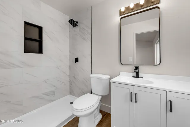 a bathroom with a toilet and a shower