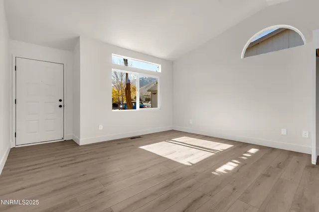 a view of kitchen with wooden floor electronic appliances and window