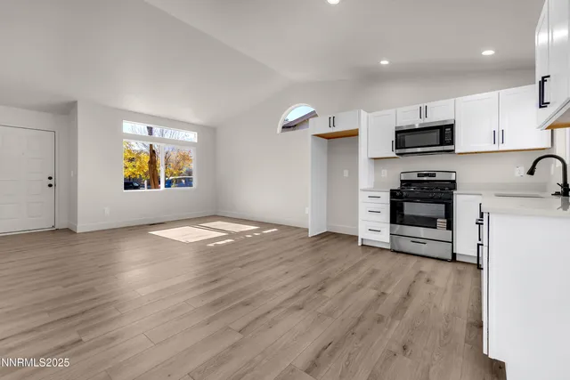 a view of a kitchen with a sink and a stove top oven