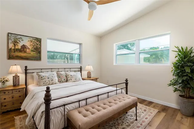 a bathroom with a bathtub sink mirror vanity and toilet