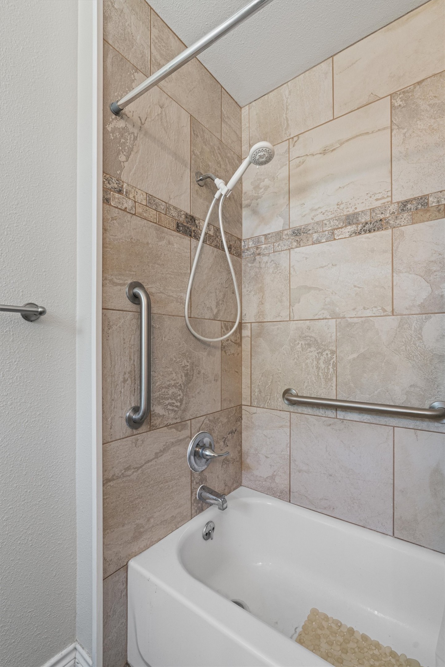 400 East Logan Street Round Rock, TX 78664 - Photo 14 of 25 a bathroom with a bath tub with a shower