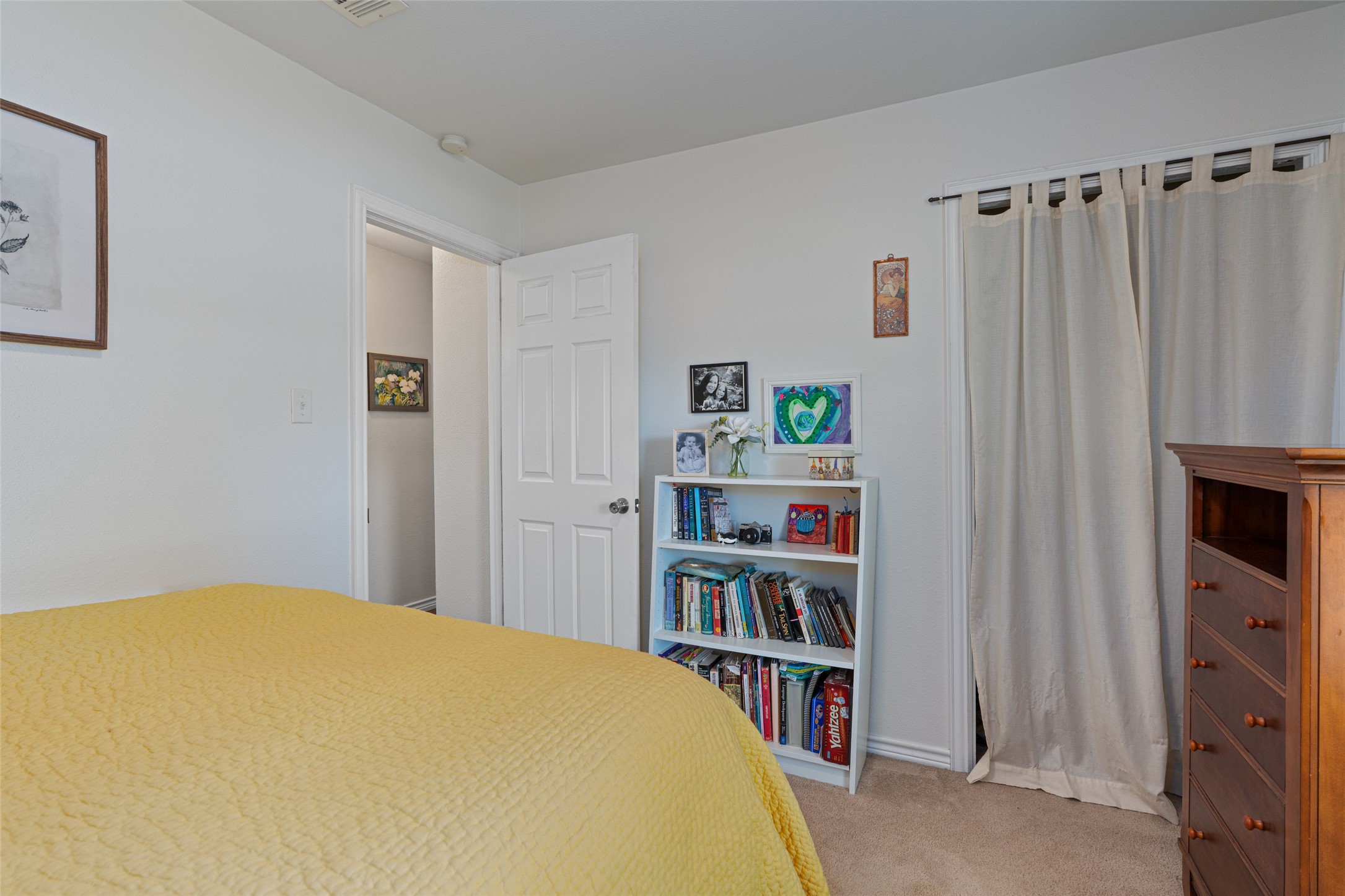 400 East Logan Street Round Rock, TX 78664 - Photo 17 of 25 a bedroom with a bed and a book shelf