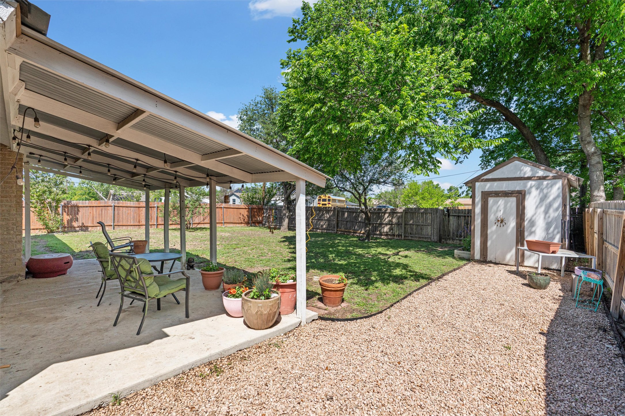 400 East Logan Street Round Rock, TX 78664 - Photo 23 of 25 a view of a patio with a table chairs and a backyard