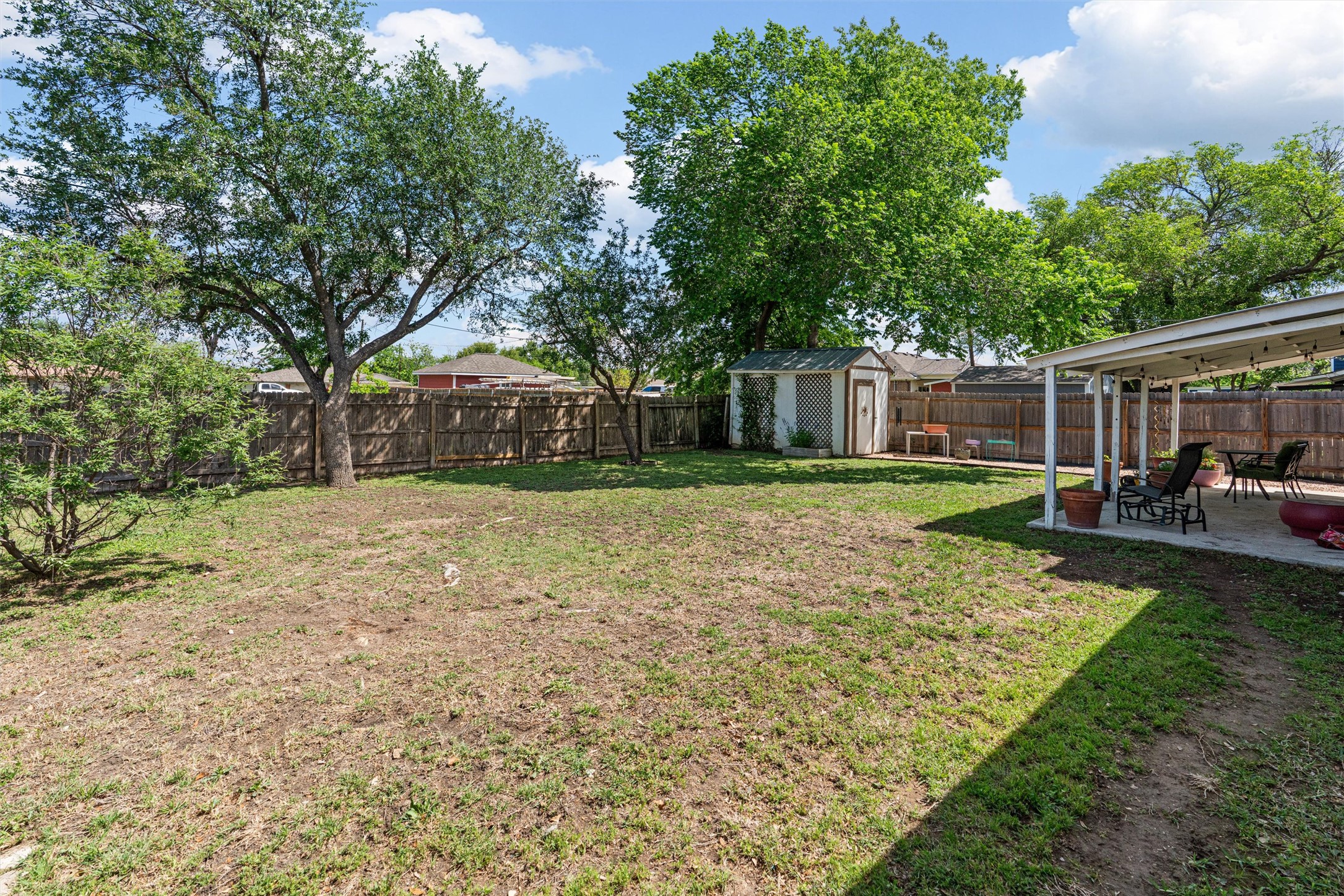 400 East Logan Street Round Rock, TX 78664 - Photo 25 of 25 a view of a backyard with a garden and trees