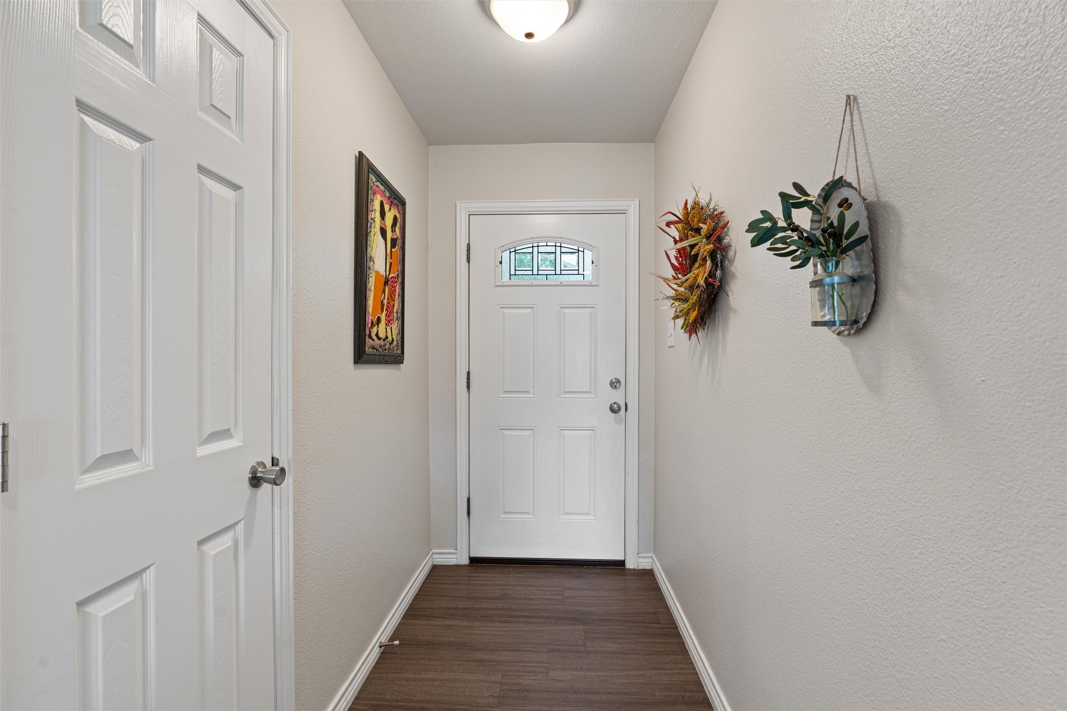 400 East Logan Street Round Rock, TX 78664 - Photo 4 of 25 a view of a hallway with wooden floor and entryway