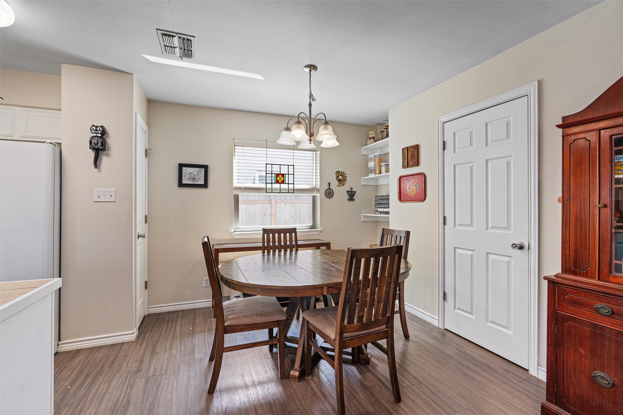 400 East Logan Street Round Rock, TX 78664 - Photo 8 of 25 a view of a dining room with furniture window and wooden floor