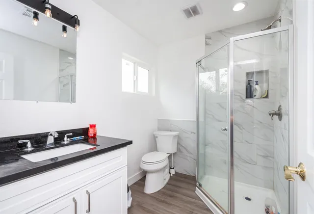 a bedroom with furniture and a book shelf