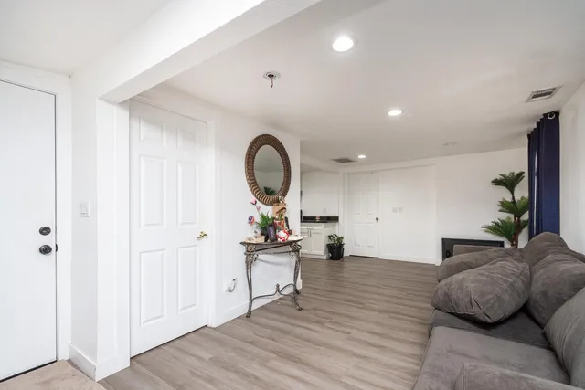 a living room with furniture and wooden floor