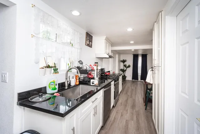 a view of a hallway with wooden floor and closet