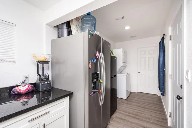 a bathroom with a granite countertop sink a toilet and shower