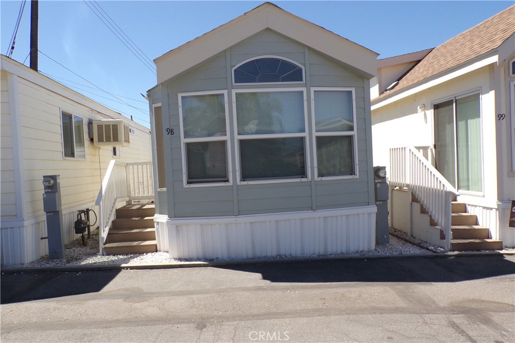 12710 3rd Street, Unit 98 Yucaipa, CA 92399 - Photo 1 of 1 a front view of a house with a yard