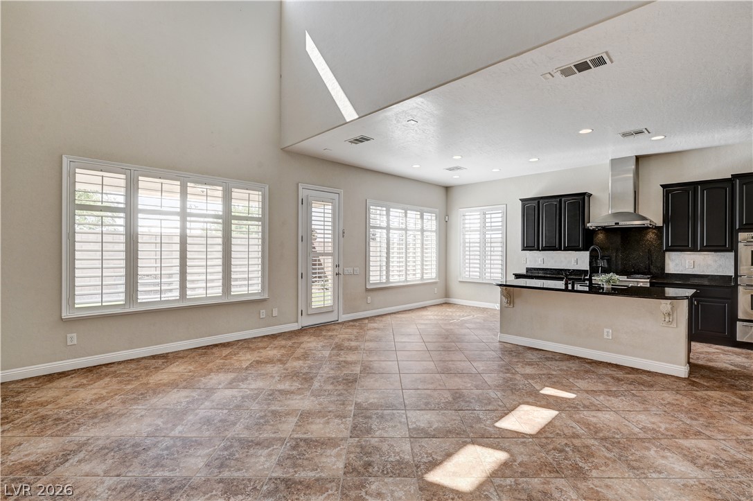 2793 Rosenhearty Drive Henderson, NV 89044 - Photo 75 of 77 An open floorplan merges a functional kitchen with a sun-filled living area, perfect for daily living and entertaining.