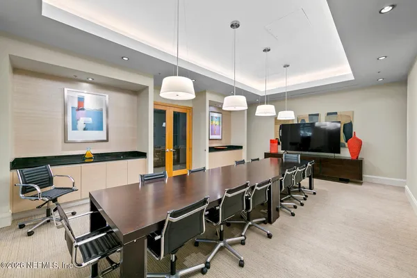 a living room with furniture a rug and a flat screen tv