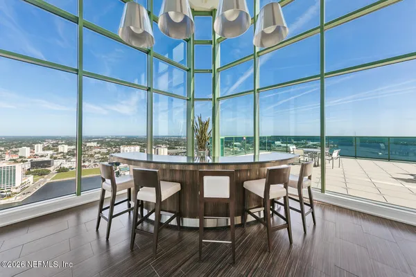 a view of a dining room with furniture window and wooden floor