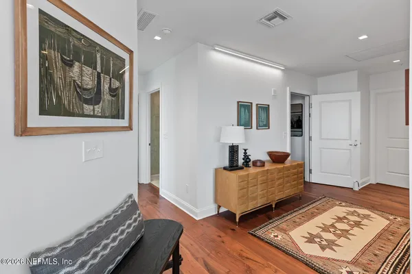 a large kitchen with stainless steel appliances lots of counter space and wooden floor