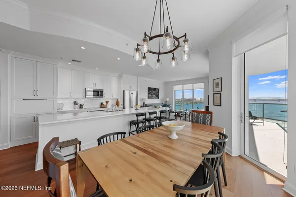a view of a dining room with furniture window and wooden floor