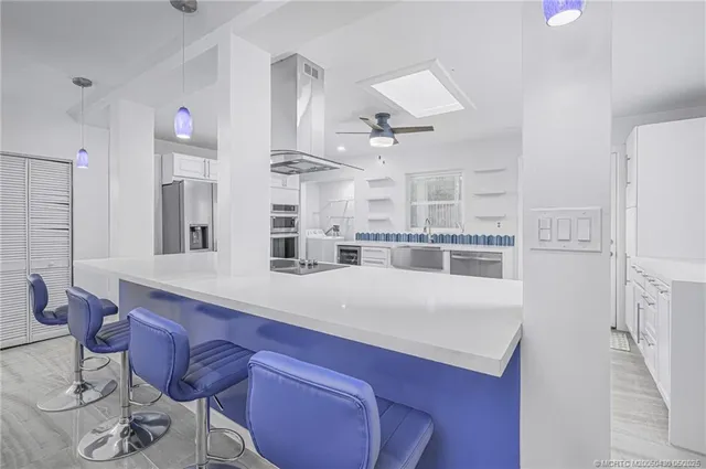 a kitchen with a white cabinets and stove top oven