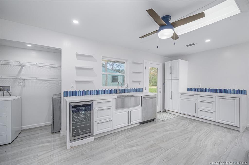 7007 South Indian River Drive Fort Pierce, FL 34982 - Photo 13 of 23 a kitchen with a white cabinets and stove top oven